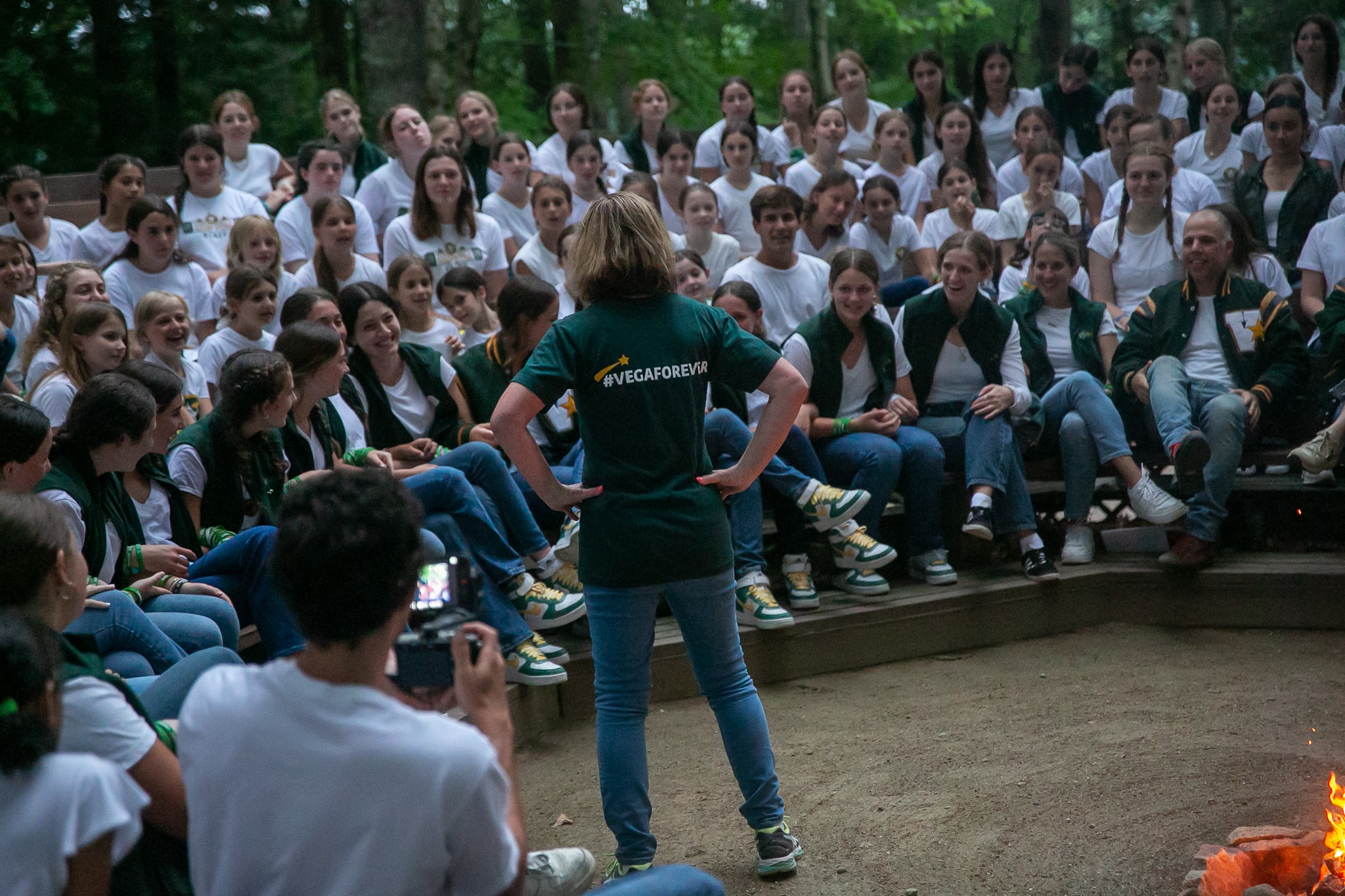 Campers and staff gather around the fire at Sunset Circle.